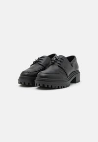 Zwarte leren veterschoenen met een ronde neus en een getextureerde rubberen zool. Bevat stikdetails en een lage blokhak.
