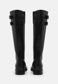 Black knee-high boots made of smooth leather with three buckle accents on the top, featuring a sturdy, low black heel.