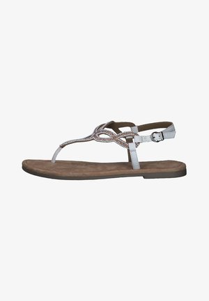 Flat sandal with a brown faux suede insole, white synthetic upper, braided silver accents, and an adjustable ankle strap with a buckle.