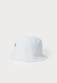 White cotton bucket hat with a textured surface and a round brim. Features a black embroidered logo on the side.