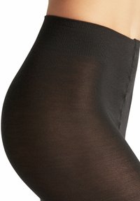 Zwarte ondoorzichtige tights met een hoge taille, met een gladde textuur en een subtiele glans. De tailleband is breed en elastisch.