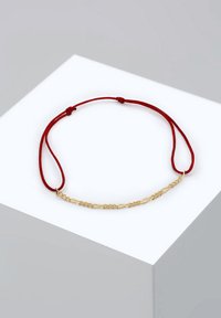 Röd trådarmband med en central design av guldkedjelänk, som visar en slät yta och enkel, modern estetik.