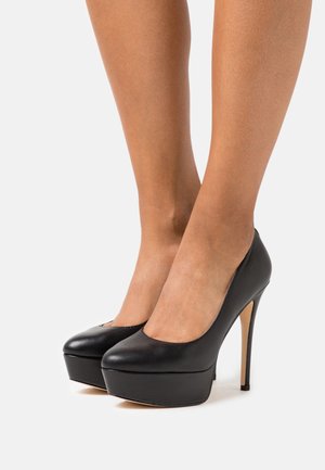 Black high-heeled pumps with a rounded toe, smooth leather upper, and a platform sole featuring a slender stiletto heel.