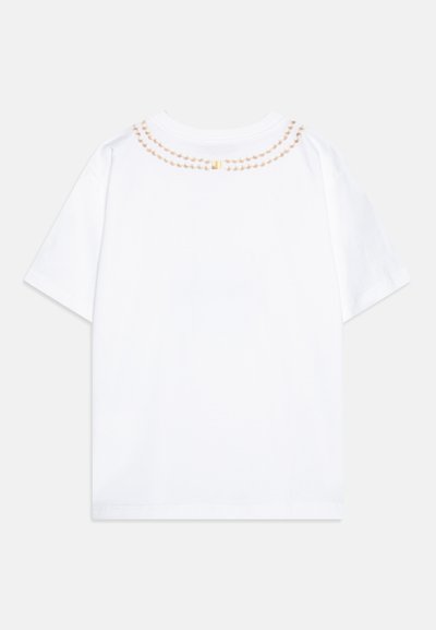 White short-sleeve t-shirt featuring a decorative ribbed neckline with a pearl-like pattern and a small gold accent.