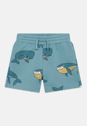 Pantaloncini a tema oceanico in cotone turchese con una texture morbida. Presentano divertenti grafiche di balene in vari colori. Vita elasticizzata con coulisse.