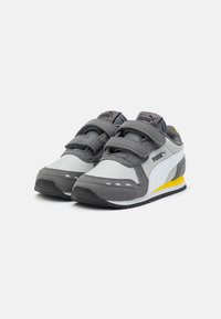 Gray and white Puma children's sneakers with double Velcro straps and yellow accents on the sole, shown side by side on a white background.