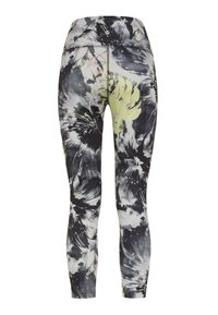 Höga leggings med ett blommigt svart och gult mönster. Tillverkade av stretchigt tyg med en mjuk textur och en åtsittande design.
