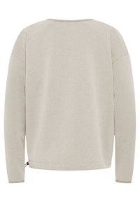 Helle beige Sweatshirt mit weichem Material, Raglanärmeln und einem kleinen verstellbaren Kordelzug am unteren Saum. Keine sichtbaren Muster oder Hardware.