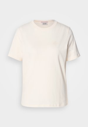 Cream-colored cotton T-shirt with short sleeves, crew neck, and subtle embossed logo detail on the front. Smooth texture, relaxed fit.