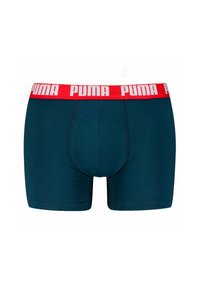 Boxer ajustados azul oscuro con una cinturilla roja que presenta el logo blanco de "PUMA". El material es suave con un diseño ajustado y bolsa frontal.