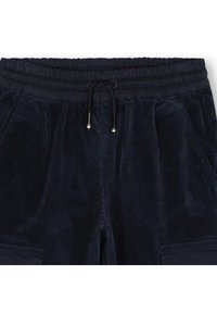 Marineblå kordfløyel joggebukser med elastisk midjebånd, snor og sidelommer. Teksturert stoff med vertikalt ribbemønster.