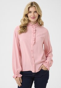 Pink button-up blouse with ruffled collar and cuffs. Made of smooth fabric, features long sleeves and a relaxed fit.