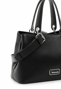 Sac à main en cuir noir avec doubles poignées, bandoulière réglable avec boucle, fermeture éclair argentée et plaque logo de la marque en métal sur le devant.