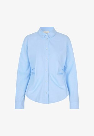 Sky blue button-up shirt, long sleeves, classic collar, soft cotton material, subtle side gathers, and pearlescent buttons.