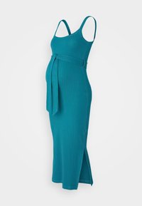 Türkisfarbenes, geripptes Umstandskleid mit verstellbaren Trägern, Bindegürtel und seitlichen Schlitzen. Figurbetonter Schnitt, der für Komfort während der Schwangerschaft sorgt.