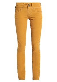 Žluté kordové skinny džíny s hladkou texturou, dvěma předními kapsami a dvojitým knoflíkovým zapínáním v pase.