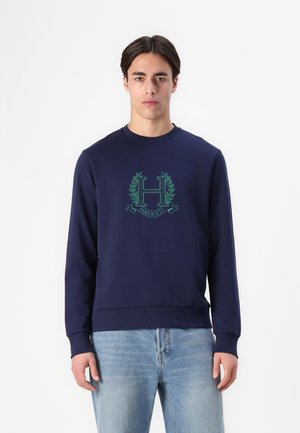 Navy blue sweatshirt made of soft fabric, featuring a green embroidered logo with laurel leaves and "HACKETT" text, crew neckline, and ribbed cuffs.