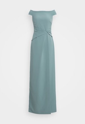 Robe longue jusqu'au sol, de couleur bleu sarcelle, à épaules dénudées avec un détail de nœud torsadé à la taille et une silhouette droite et lisse.
