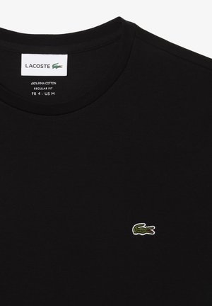 Zwarte T-shirt gemaakt van 100% Pima-katoen, met een klassieke ronde hals, normale pasvorm en een klein geborduurd groen krokodillenlogo.