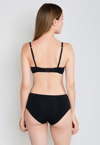 Black lingerie set featuring a smooth bra with adjustable straps and hook closure, paired with matching high-waisted briefs with scalloped edges.