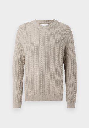 Beige knitted sweater with a ribbed texture, featuring a crew neck and long sleeves. The design includes cable knit patterns throughout.
