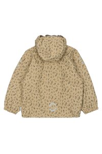 Giacca impermeabile beige chiaro con un piccolo motivo a foglie nere, con polsini elastici e cappuccio. Presenta un logo stampato in grigio chiaro nella parte inferiore.