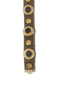 Cinturino in pelle marrone decorato con borchie dorate e nere, con dettagli rotondi e testurizzati, creando un motivo decorativo lungo tutta la sua lunghezza.
