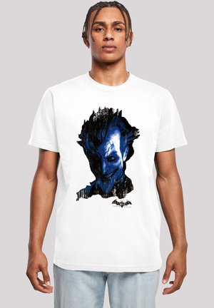 White cotton t-shirt featuring a blue and black graphic of a character's face, with jagged edges and a logo at the bottom.