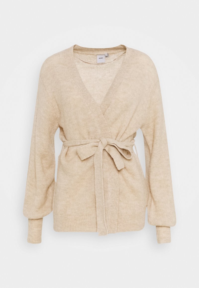 Beige stickad cardigan med djup v-ringning, långa ärmar och midjebälte. Mjukt material med en subtil mönstring, åtsittande muddar och en avslappnad silhuett.