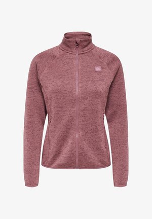 Vilnos striukė rausvai violetinė spalva, su aukštu apykakliu, užtrauktuku visame ilgyje ir raglaninėmis rankovėmis. Turi tekstūruotą raštą ir mažą logotipą ant krūtinės.