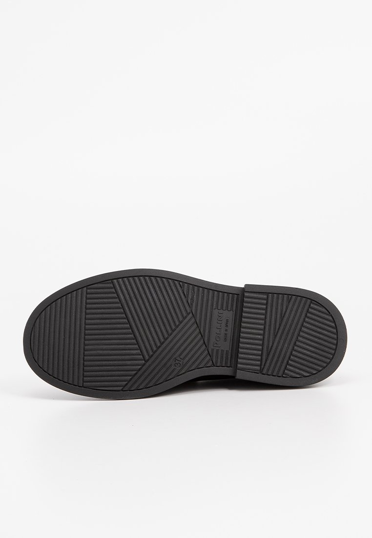 Czarna gumowa podeszwa buta z teksturowanym wzorem, zawierająca różne desenie i rowki dla lepszej przyczepności. Okrągły nadruk logo w pobliżu pięty.