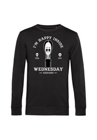 Maglietta nera a maniche lunghe con grafica bianca di Mercoledì Addams, testo "Sono felice dentro" sopra, teschi etichettati "sì" e "no," e "Mercoledì Addams" sotto.