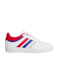 Zapatilla blanca con rayas rojas y azules, que cuenta con una parte superior de cuero liso, cuello acolchado y suela de goma texturizada. Logo de Adidas en el lateral.