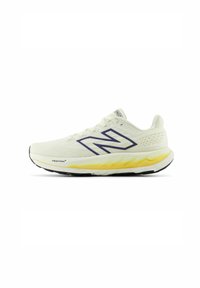 Miestne bežecké topánky New Balance v svetlej krémovej farbe s priedušným sieťovaným vrchom. Medzi funkcie patrí výrazné tmavomodré logo a žlté odpruženie.