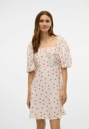 Vestido ligero de crema con escote cuadrado, mangas abullonadas y un patrón de puntos rojos. Presenta un ajuste relajado y una tela texturizada.