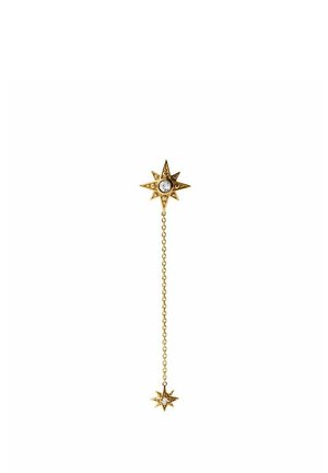 Pendiente dorado en forma de estrella con una gema transparente en el centro, conectado mediante una cadena fina a una estrella más pequeña a juego con una gema en el centro.