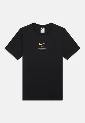 Black Nike t-shirt with small yellow swoosh and white text displaying Nike Inc. address centered on chest, short sleeves, crew neck.