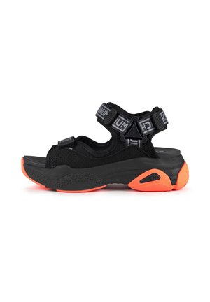 Black sandals featuring mesh upper material, adjustable straps, and a robust sole with bright orange accents, designed for comfort and support.