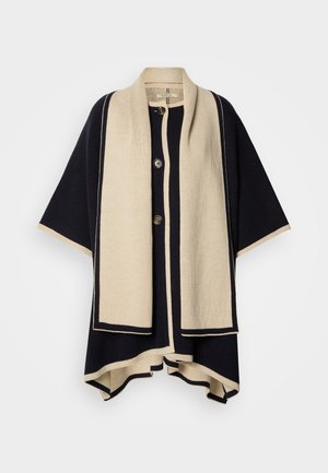 Swetrowy ponczo w kolorze granatowym i kremowym, z szerokim kołnierzem, trzema guzikami i strukturalnym krojem. Charakteryzuje się kontrastowymi krawędziami i miękką teksturą.