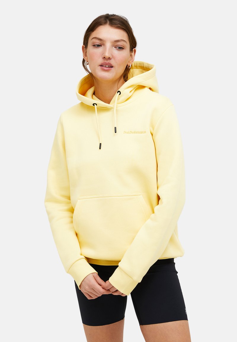 Pullover-Hoodie aus weichem gelben Stoff mit verstellbaren Kordeln, frontaler Kängurutasche und gerippten Bündchen. Leichtes und lässiges Design.