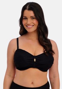 Černý bikiny top s řasenou texturou, který má centrální zlatý akcent a nastavitelné ramenní popruhy. Hladká látka, podprsenková podpora.