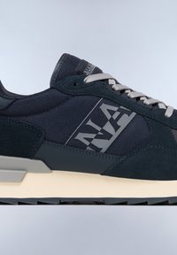 Men’s navy sneaker with a textured fabric upper, suede accents, grey laces, and a chunky cream midsole. Features a logo on the side.