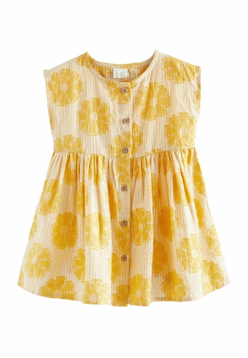 Vestido sin mangas amarillo y blanco a rayas con gran bordado floral amarillo y botones de madera en la parte delantera para un niño.