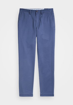 Blaue Chinos aus einem Baumwoll-Mix, mit einem klassischen Schnitt, seitlichen Taschen und einem Knopfverschluss an der Taille. Glatte Textur.
