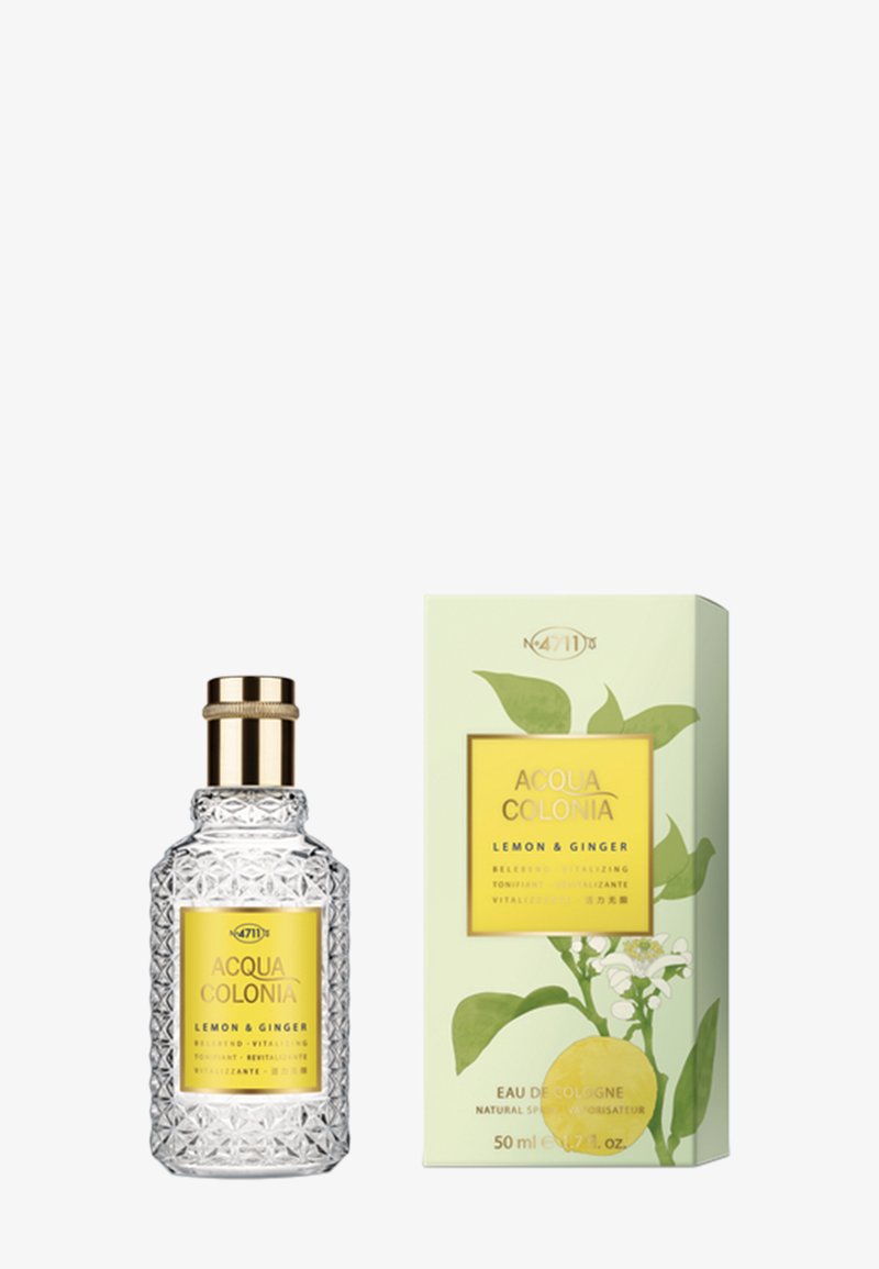 Acqua Colonia Lemon & Ginger Eau de Cologne in einer strukturierten Glasflasche mit goldfarbenem Verschluss neben einer grünen Schachtel mit Zitronen- und Blätterillustration.