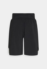 Short de sport noir taille haute avec une large ceinture et des jambes amples, conçu pour le confort et une utilisation active.