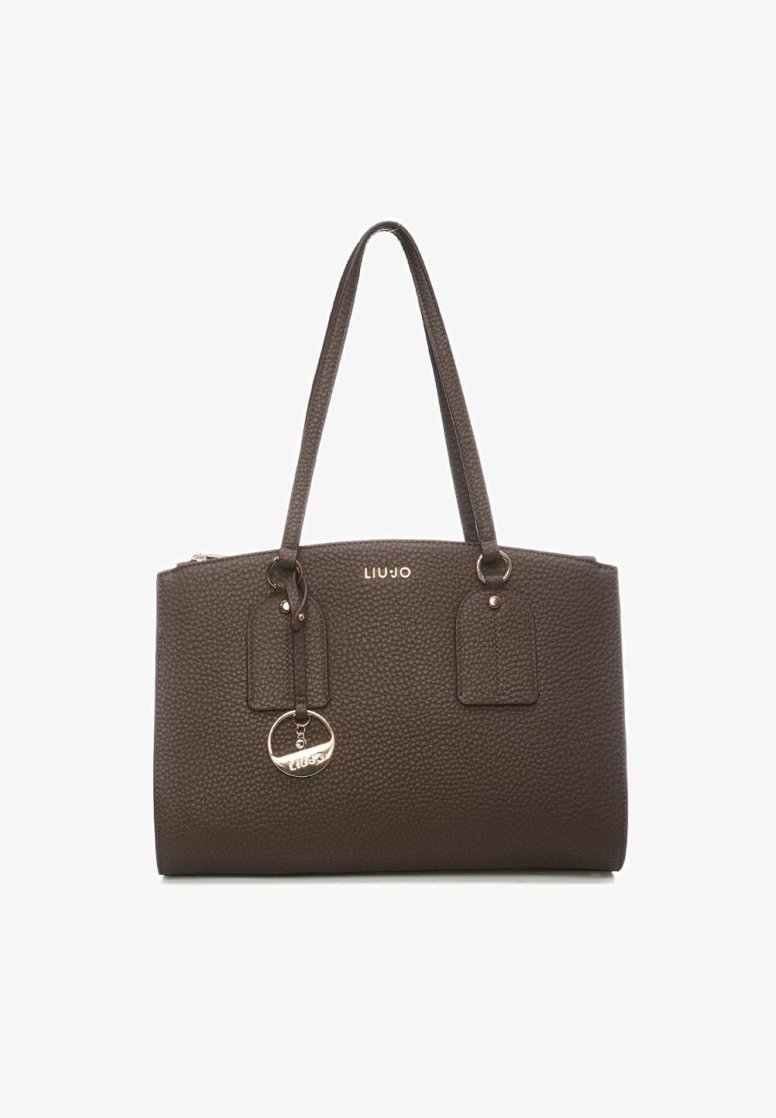 Sac à main en cuir brun foncé texturé avec double bandoulière, breloque en métal et petite plaque portant le logo de la marque à l’avant.