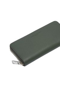 Zielony portfel ze skóry o teksturowanej powierzchni, wyposażony w srebrny zamek błyskawiczny i wytłoczony logo. Prostokątny kształt i smukły design.