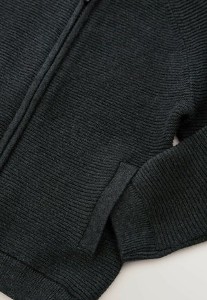 Dark grey knitted sweater with a textured surface, featuring a front zipper, ribbed cuffs, and an inset pocket on the side.