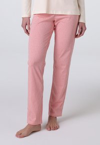 Pantaloni del pigiama leggeri di colore rosa con strisce bianche verticali. Presentano una linea dritta e una texture morbida e liscia. Design alla caviglia.
